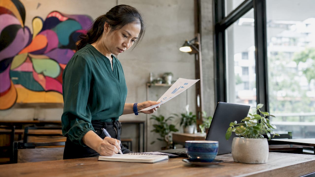 Woman analyzing website conversion data at home office