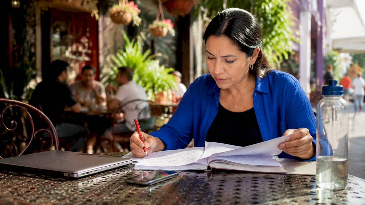 Small business owner managing cash flow documents