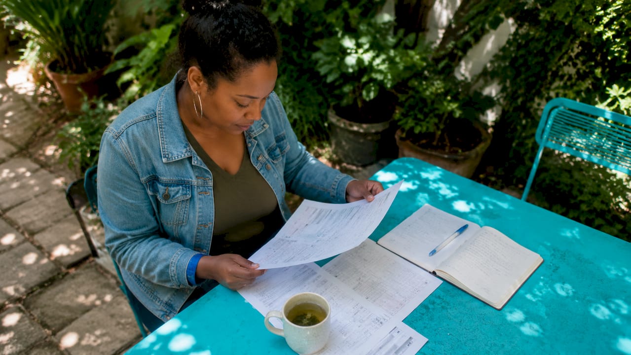 Entrepreneur reviewing customer surveys at home