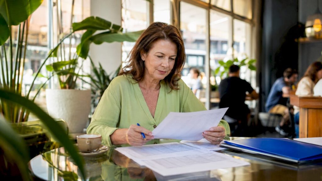 Woman reviewing lead lists at home desk