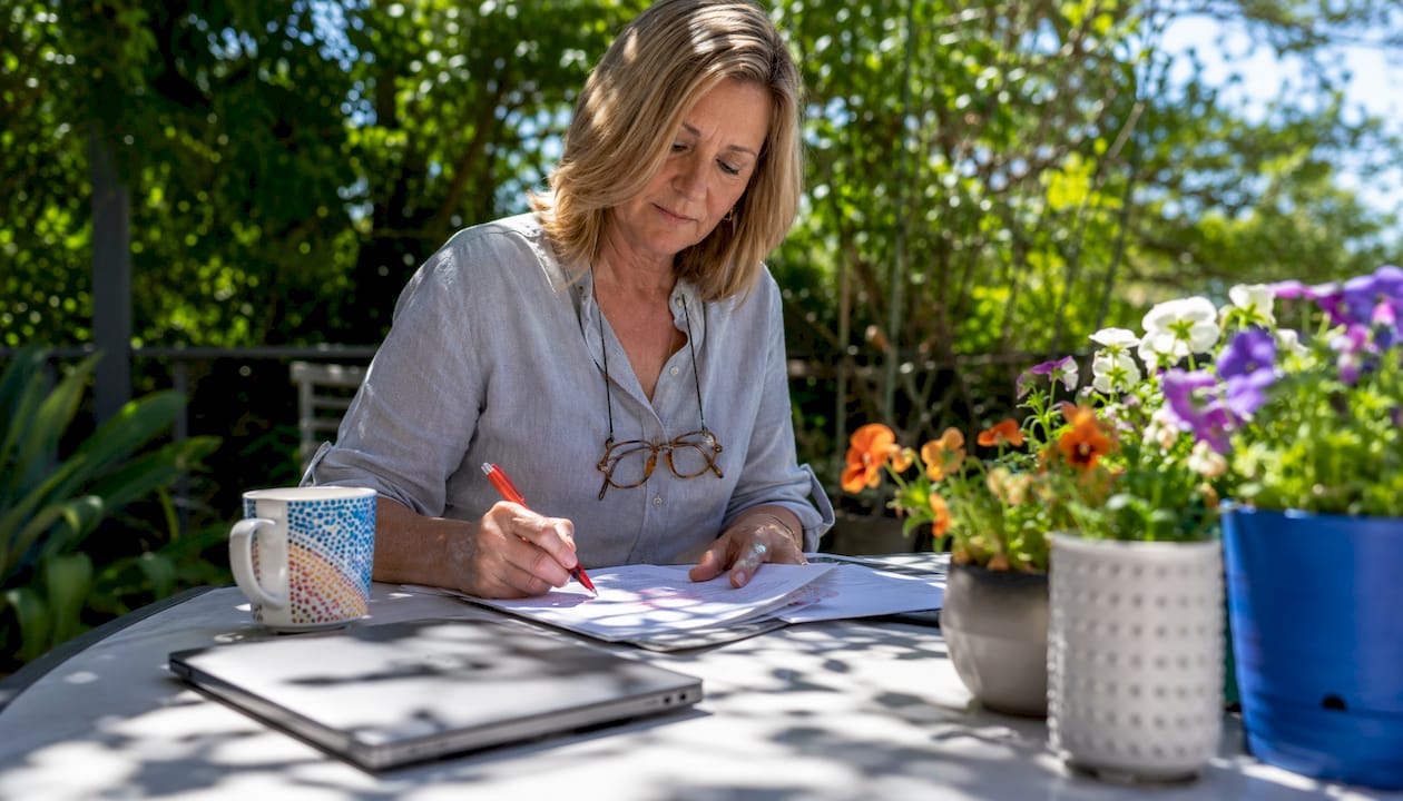 Woman highlighting website copy drafts at home office