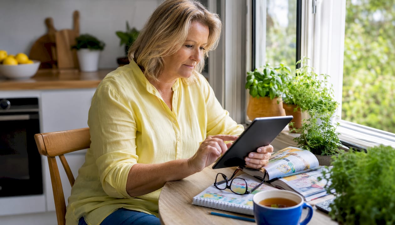 Australian midlife woman reviewing website on tablet