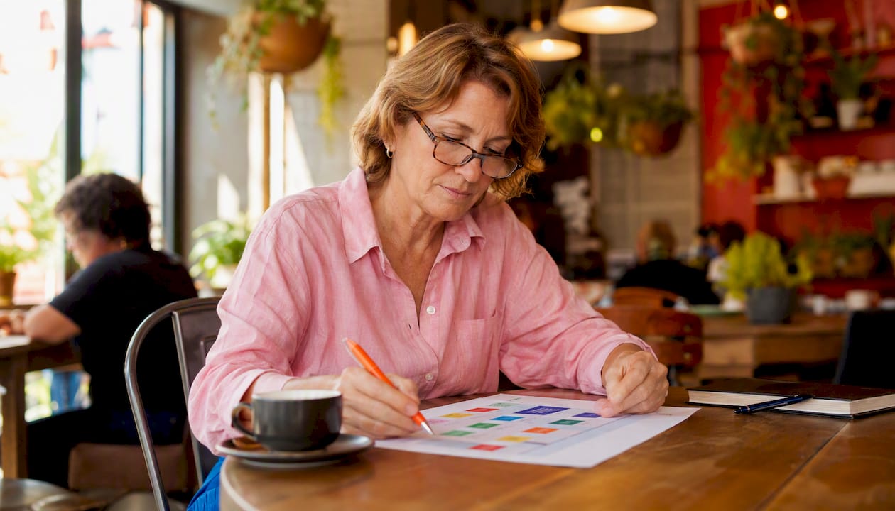Mature woman planning marketing at home table