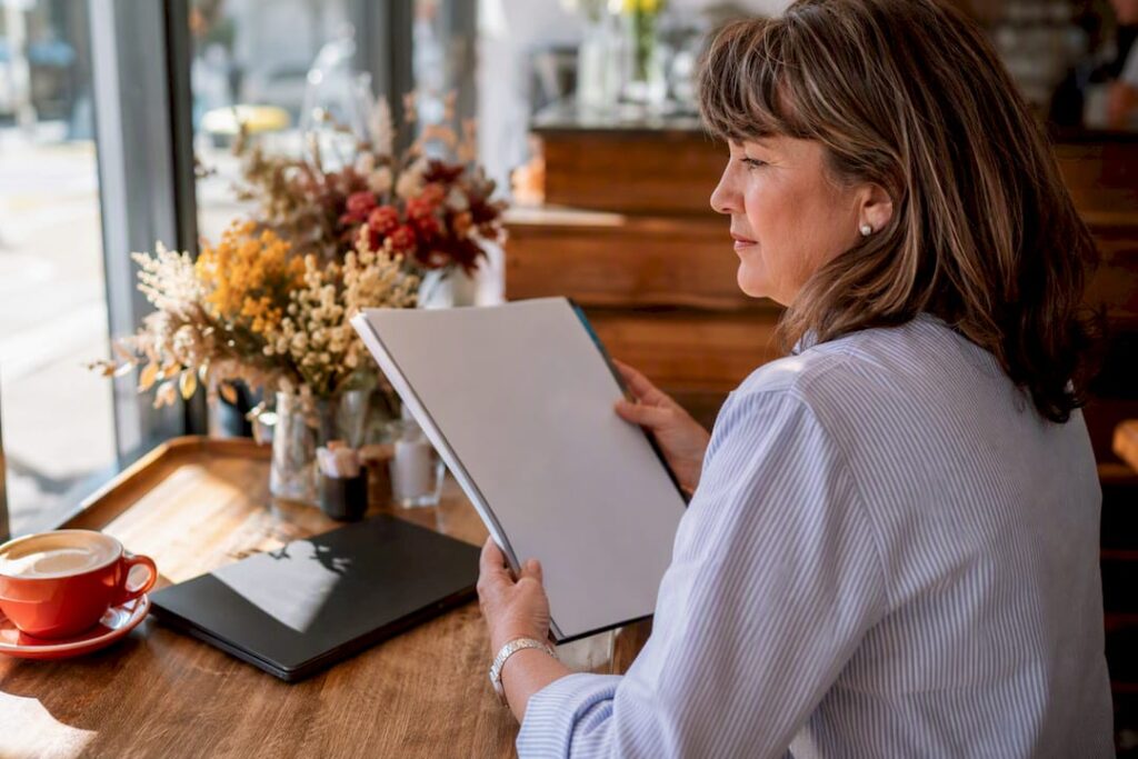 Woman holding blank copywriting brief folder