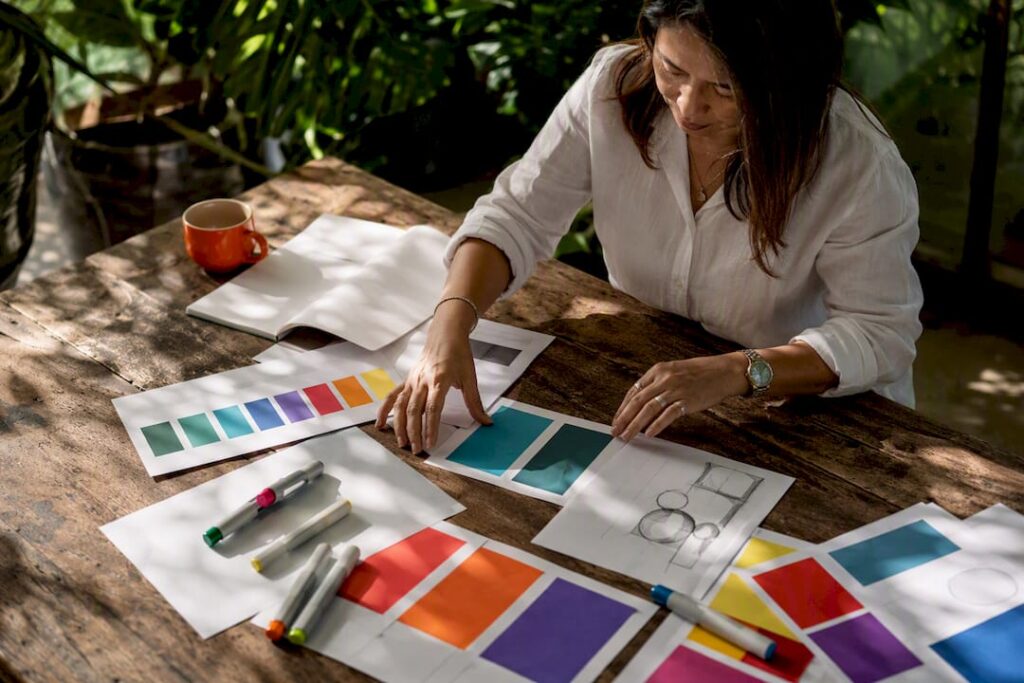 Hands arranging brand style guide materials