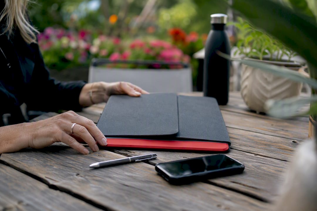 Workspace with hands arranging proposal materials