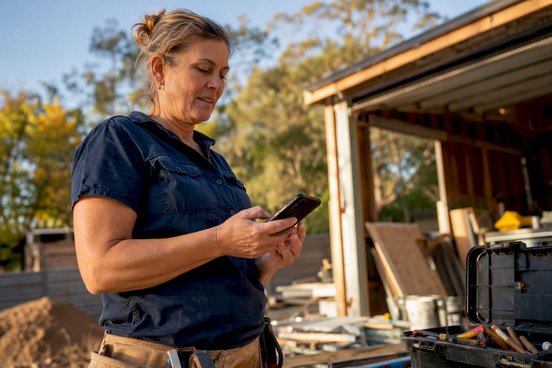 Tradie managing business profile on phone